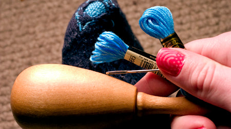 darning supplies and a mended sock