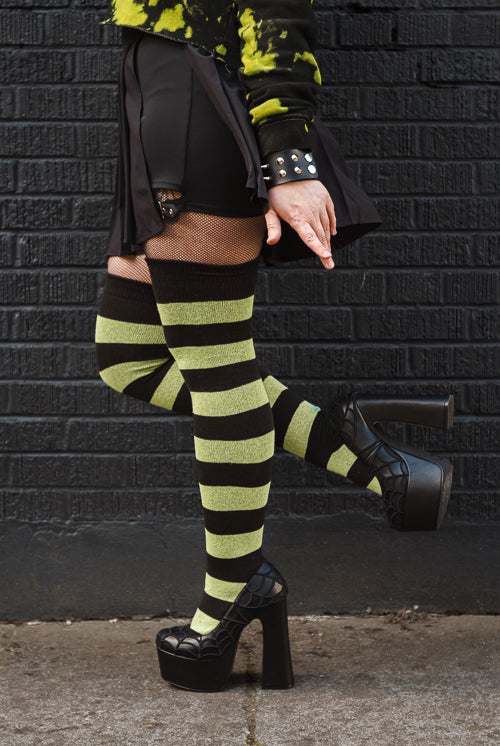 A person wearing Striped Extraordinary Thigh Highs in Black and Lime