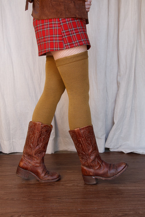 A person wearing Longer extraordinary Thigh Highs in ochre