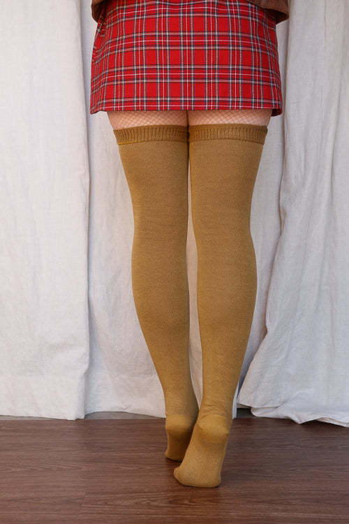 A person wearing Longer extraordinary Thigh Highs in ochre