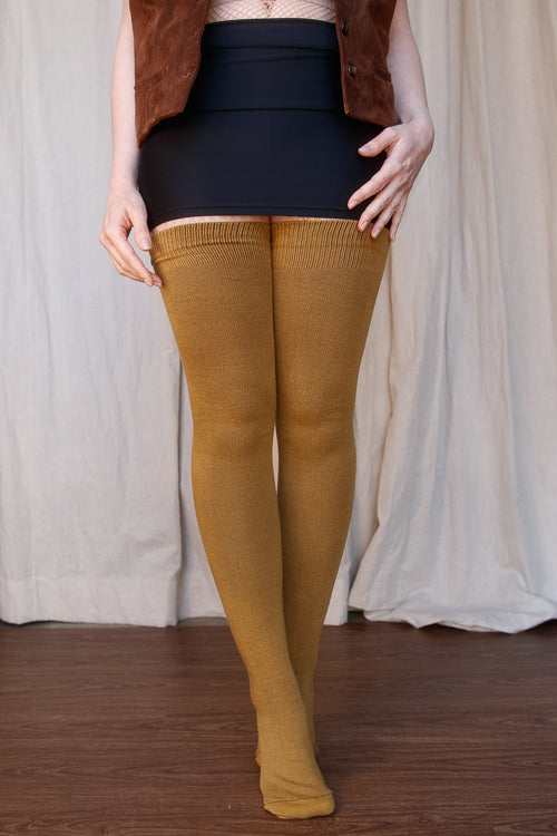 A person wearing Longer extraordinary Thigh Highs in ochre