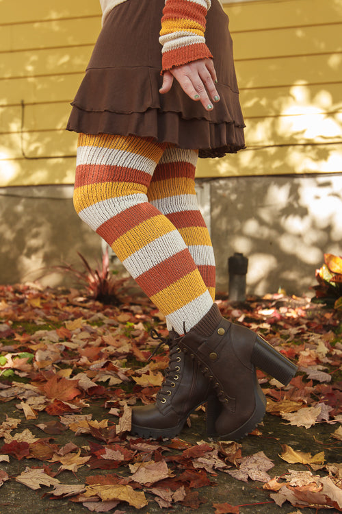 A person wearing Candy Corn striped thigh highs