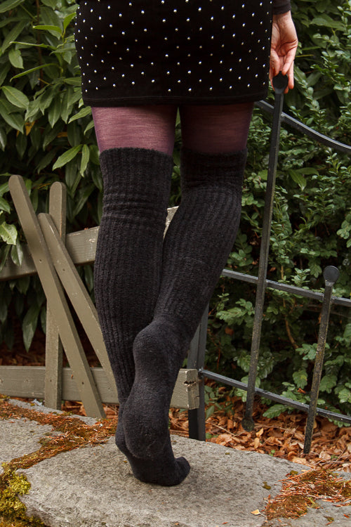 A person wearing Inky Void Chenille Thigh Highs in black