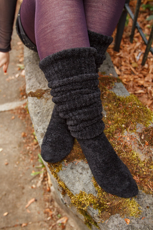 A person wearing Inky Void Chenille Thigh Highs in black