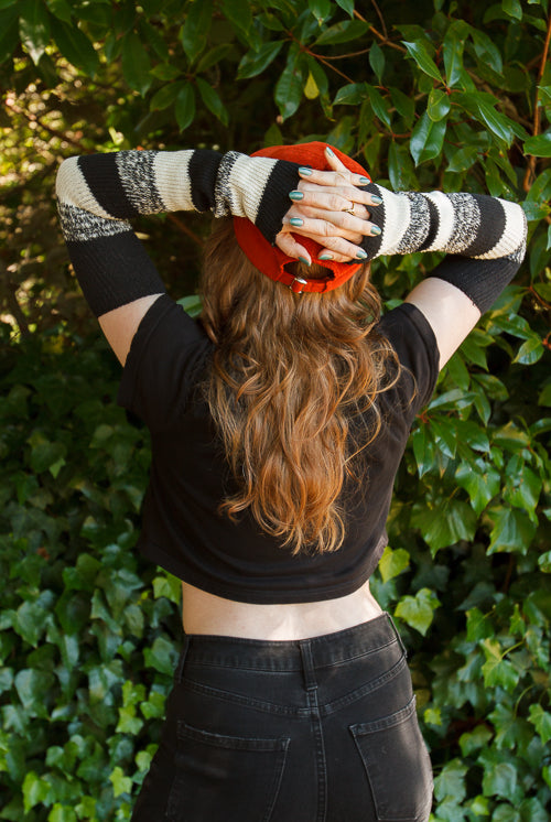 A person wearing cookies and cream stripes warmers