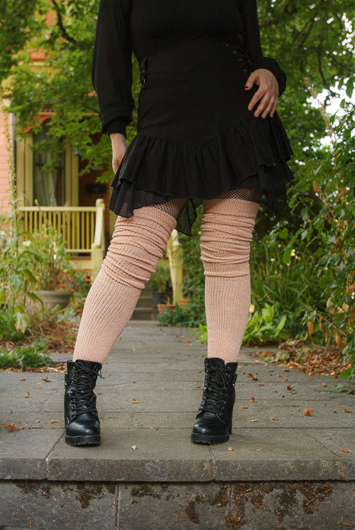 A person wearing long cuffable scrunchable socks in toe beans pink