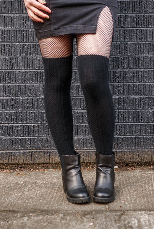 A person wearing longer diamond rib knee socks in black