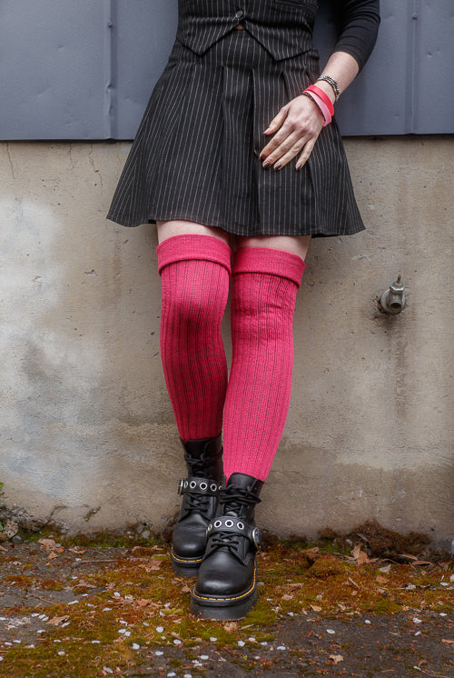A person wearing Fuchsia M45 thigh high socks with the roll top cuff folded.