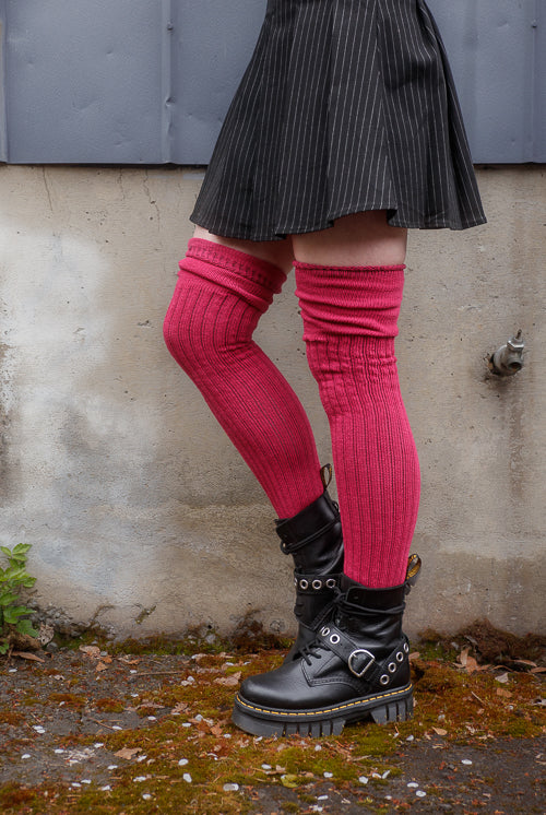 A person wearing M45 roll top thigh high socks in fuchsia