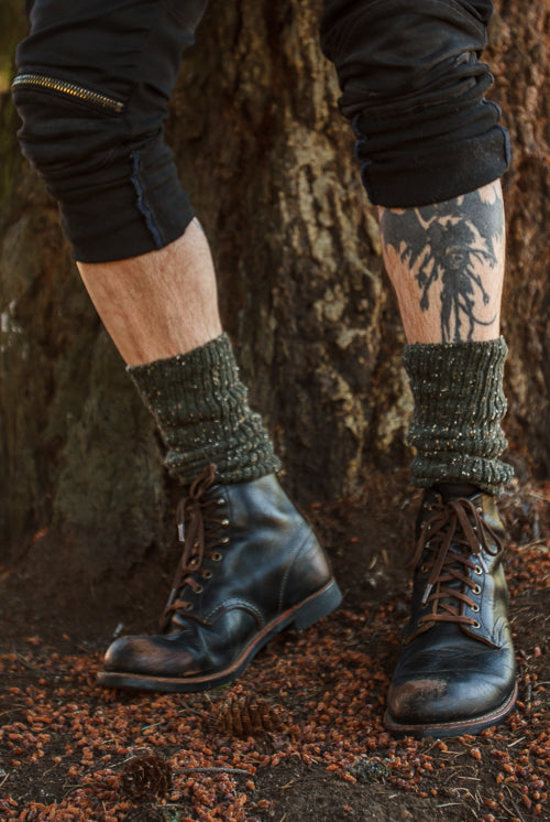 A person wearing OG Bootsocks in green