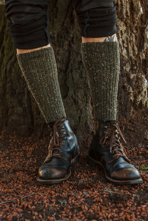 A person wearing OG Bootsocks in green