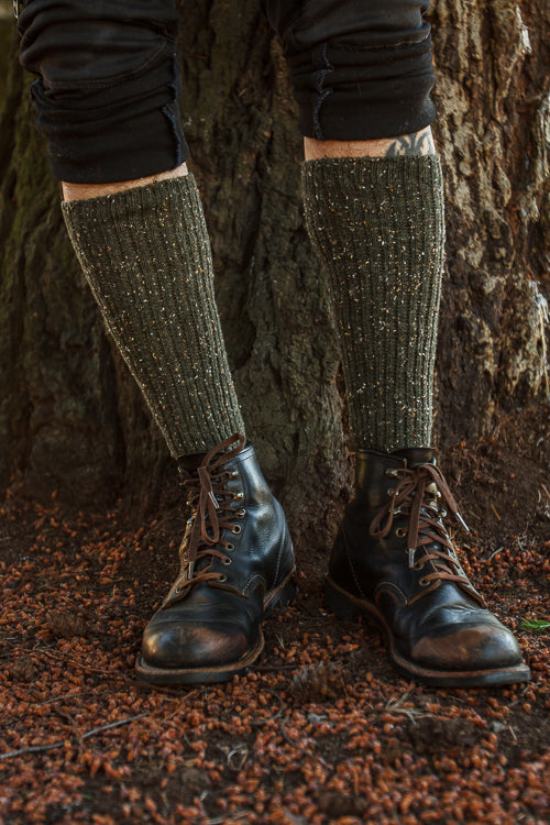 A person wearing OG Bootsocks in green