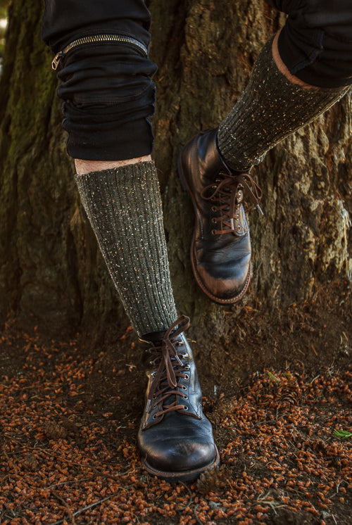 A person wearing OG Bootsocks in green