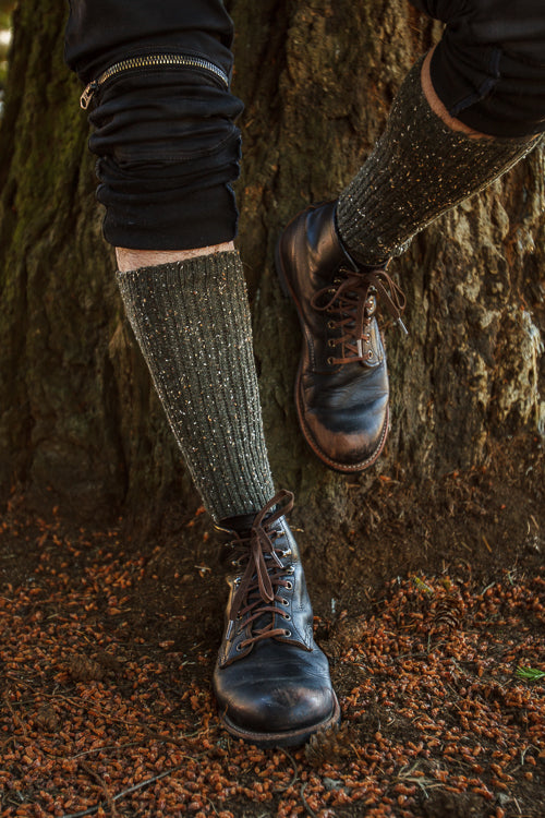 A person wearing OG Bootsocks in green