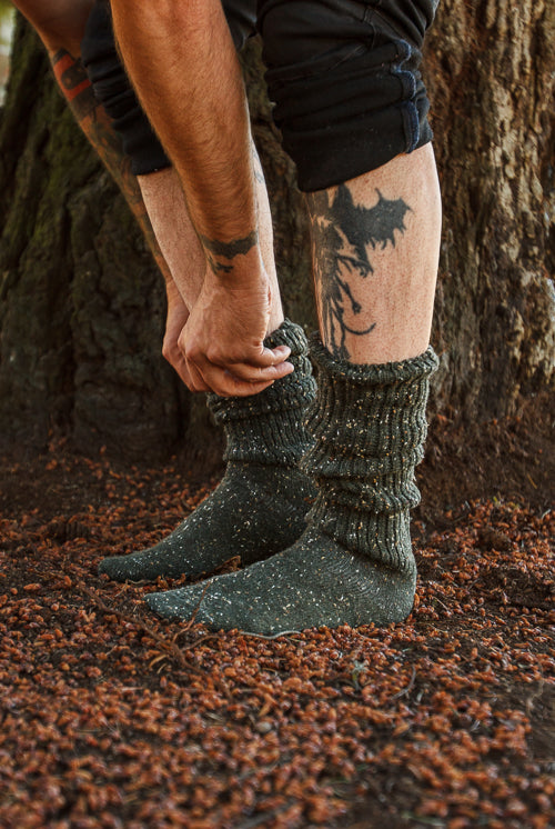 A person wearing OG Bootsocks in green