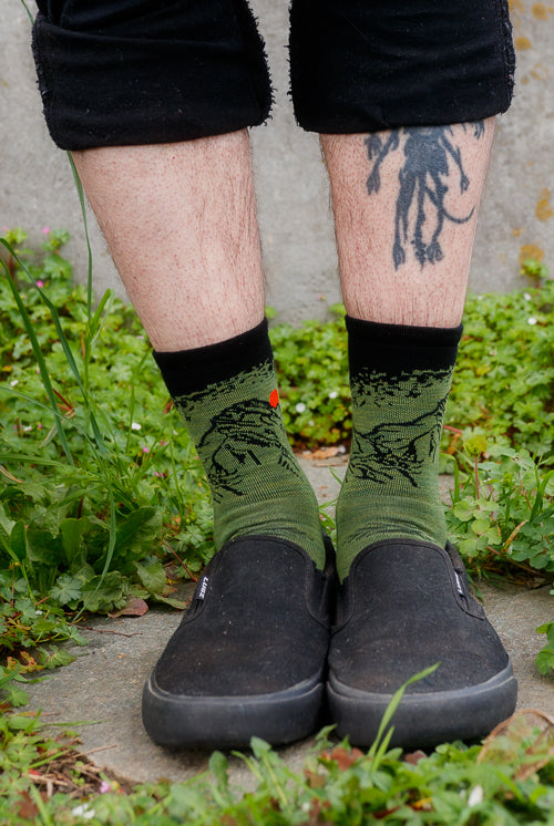 A person wearing vert micro crew in lichen color