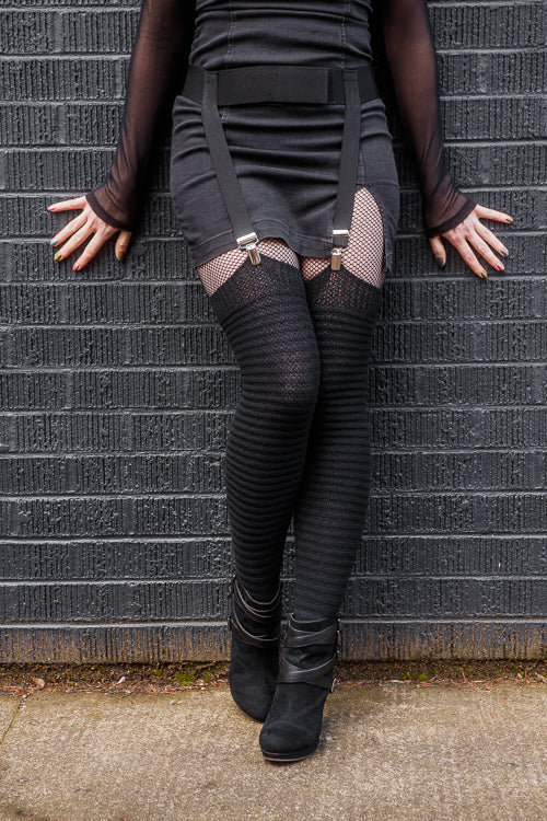A person wearing suspender clip industrial garter belt in black