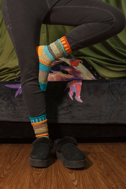 A person wearing Dune crew socks