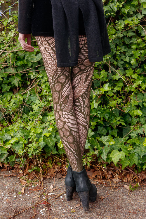 A person wearing celsius net tights in olive color