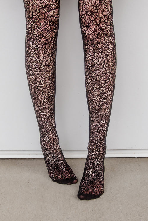 A person wearing Shedar floral net tights in black