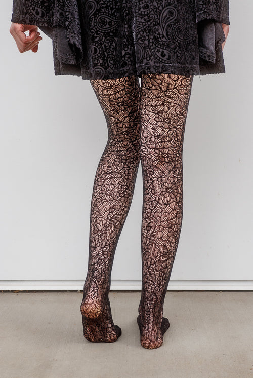 A person wearing Shedar floral net tights in black