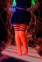 A person wearing Electric Shock thigh highs in neon orange with black stripes