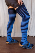 A person wearing xl foot longer gradient extraordinary thigh highs in navy and azule