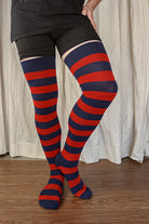 A person wearing XL foot longer extraordinary programming socks in navy and red