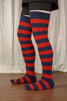 A person wearing XL foot longer extraordinary programming socks in navy and red