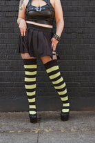 A person wearing Striped Extraordinary Thigh Highs in Black and Lime