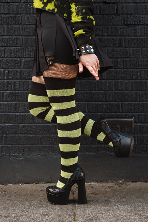 A person wearing Striped Extraordinary Thigh Highs in Black and Lime