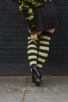 A person wearing Striped Extraordinary Thigh Highs in Black and Lime