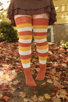 A person wearing Candy Corn striped thigh highs