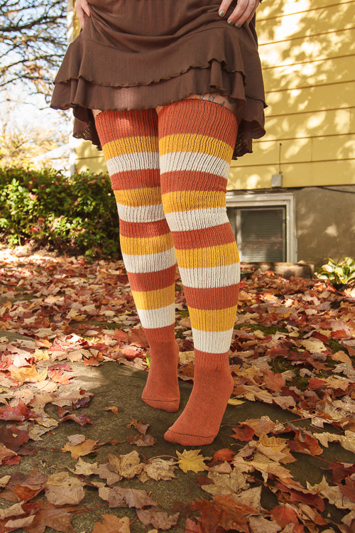 A person wearing Candy Corn striped thigh highs