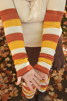 A person wearing Candy Corn striped warmers