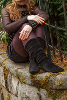 A person wearing Inky Void Chenille Thigh Highs in black