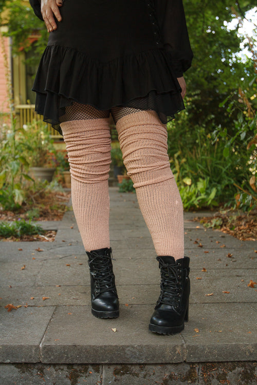 A person wearing long cuffable scrunchable socks in toe beans pink