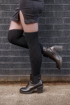 A person wearing longer diamond rib knee socks in black