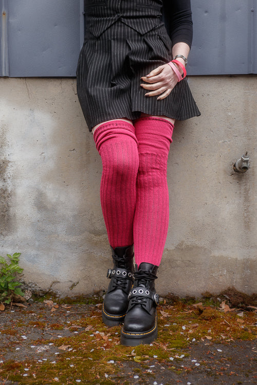 A person wearing M45 roll top thigh high socks in fuchsia