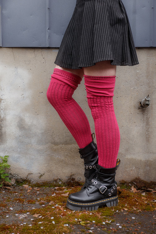 A person wearing M45 roll top thigh high socks in fuchsia
