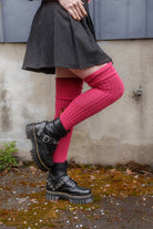A person wearing M45 roll top thigh high socks in fuchsia