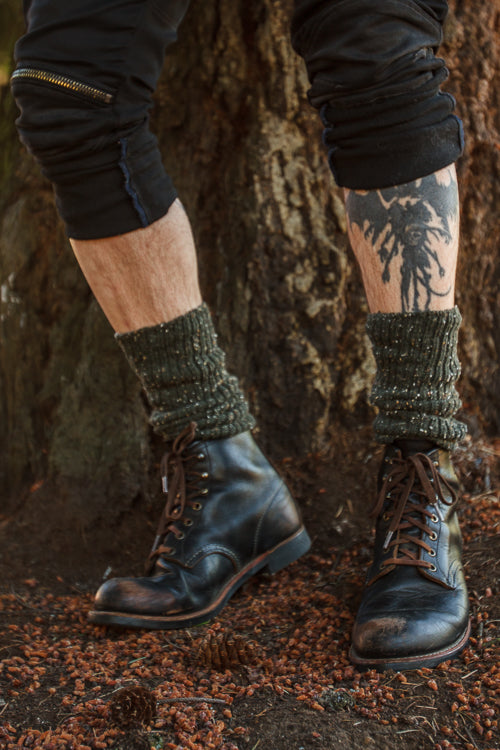 A person wearing OG Bootsocks in green