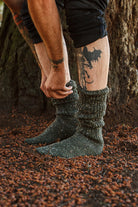 A person wearing OG Bootsocks in green