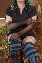 A Person wearing opera-length fishnet gloves