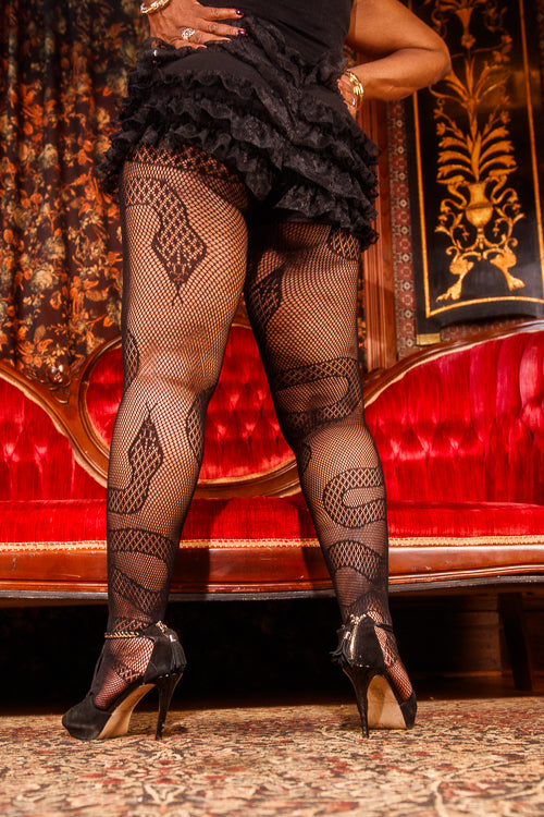 A person wearing plus size snake net tights 