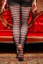 A person wearing horizontal striped net tights