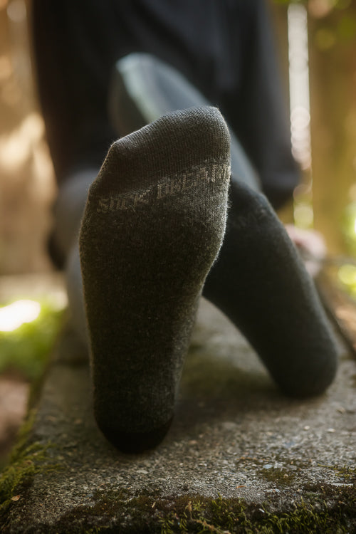 Bottoms of the feet, showing "Sock Dreams" knitted into the socks