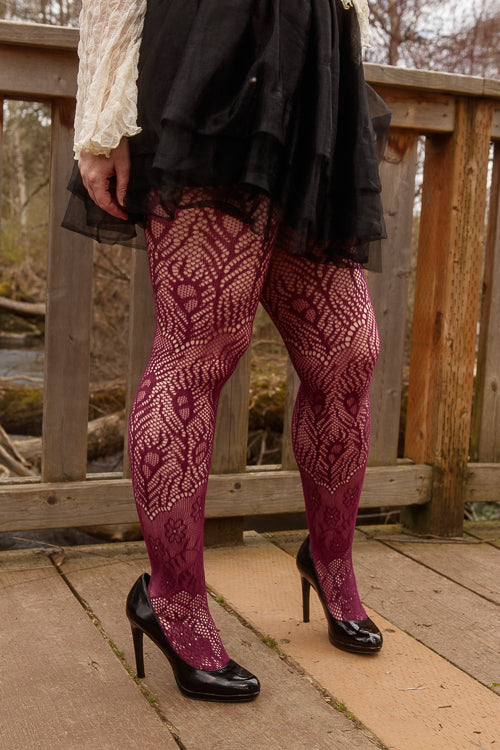 A person wearing wine-colored peacock feather net tights