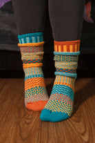 A person wearing Dune crew socks