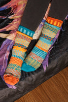 A person wearing Dune crew socks